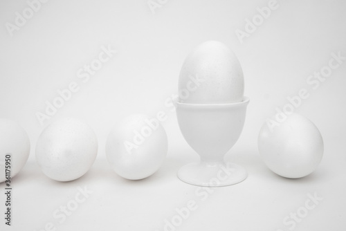 White eggs on a white background  with a cup