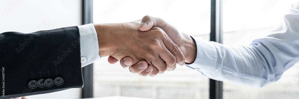Fototapeta premium Male candidate shaking hands with Interviewer employer after a job interview 