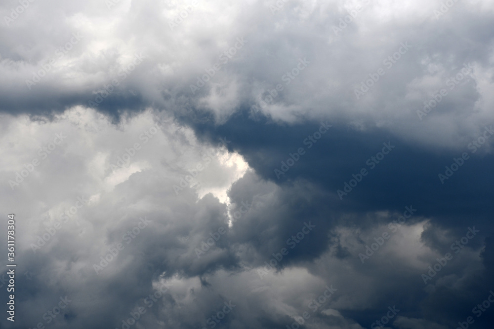 Dark and white fluffy clouds in the sky Dark and white fluffy clouds in the sky