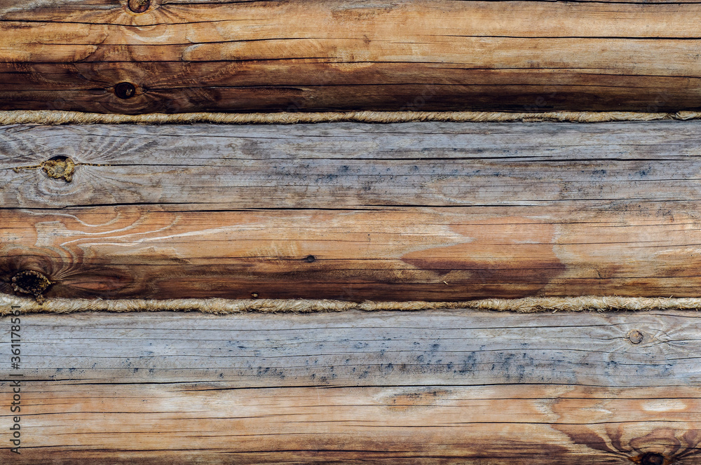 Wooden background. Logs on the wall of the log frame as a background. Wooden wall assembled of logs. Wood construction Wooden background. Logs on the wall of the log frame as a background. Wooden wall assembled of logs. Wood construction