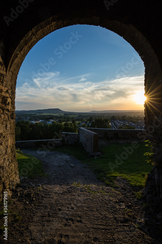 Viewpoint from Clitheroe castle looking through an arch into the Ribble valley. Sunset over Longridge fell photo