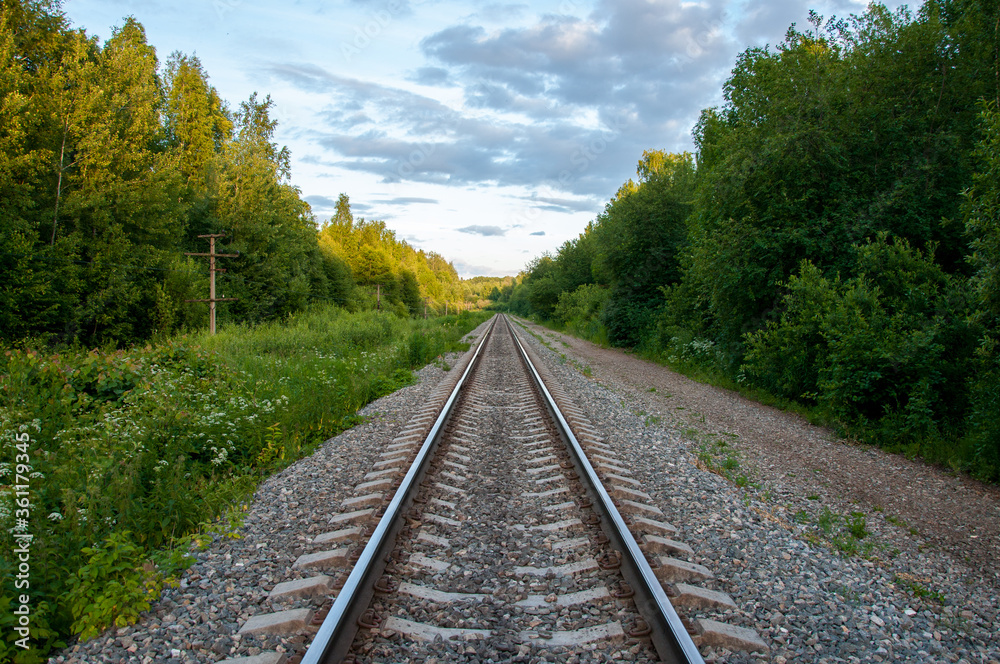 Railroad Background in the summer forest. New road. Industrial background Railroad Background in the summer forest. New road. Industrial background