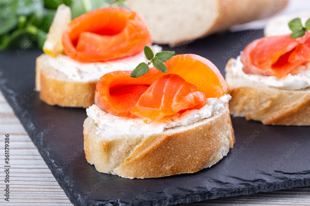 Salmon mini sandwiches on black slate board Salmon mini sandwiches on black slate board