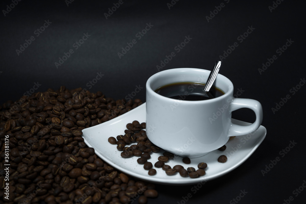 Coffee cup and coffee beans on black background Coffee cup and coffee beans on black background