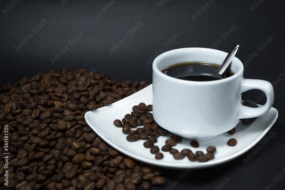 Coffee cup and coffee beans on black background Coffee cup and coffee beans on black background