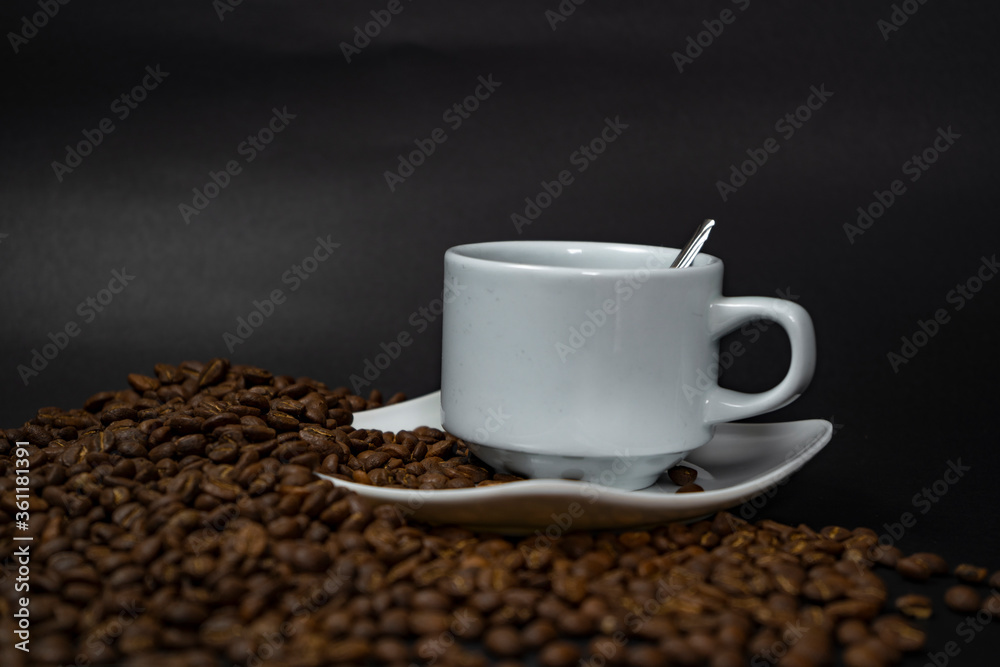 Coffee cup and coffee beans on black background Coffee cup and coffee beans on black background