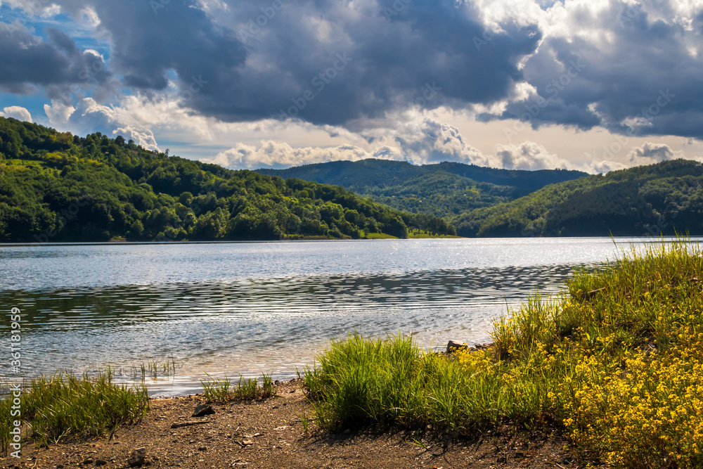 Fototapeta premium Lake on mountain, cloudy spring day. Vrutci lake on Zlatibor mountain in Serbia