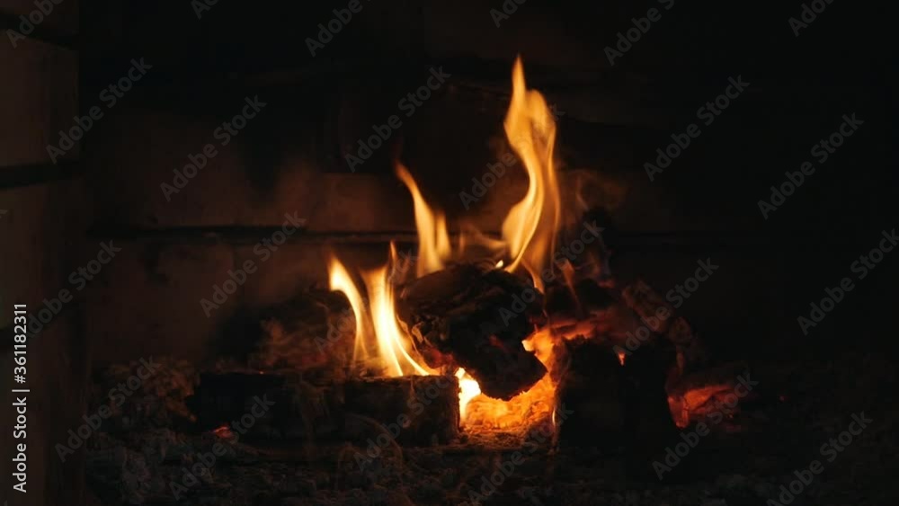 Fire in the fireplace. Firewood, coal, flame. Burning Fireplace - a luminous fire in a stone fireplace to keep warm at night Fire in the fireplace. Firewood, coal, flame. Burning Fireplace - a luminous fire in a stone fireplace to keep warm at night