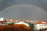 Full rainbow above buildings