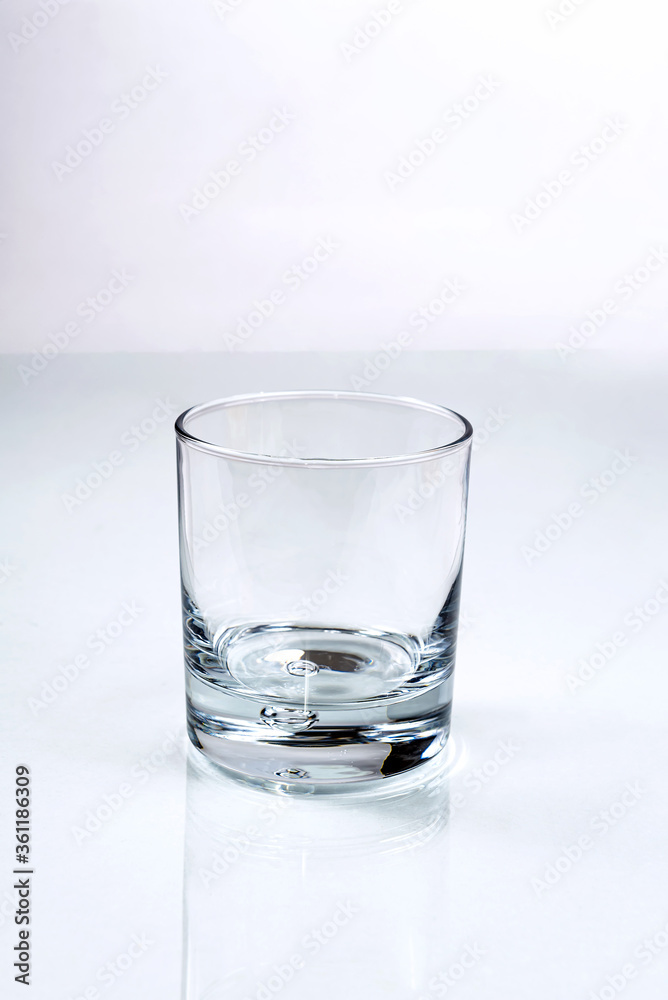 Empty glass with the air bubble in the bottom for water, juice or spirits on white background Empty glass with the air bubble in the bottom for water, juice or spirits on white background