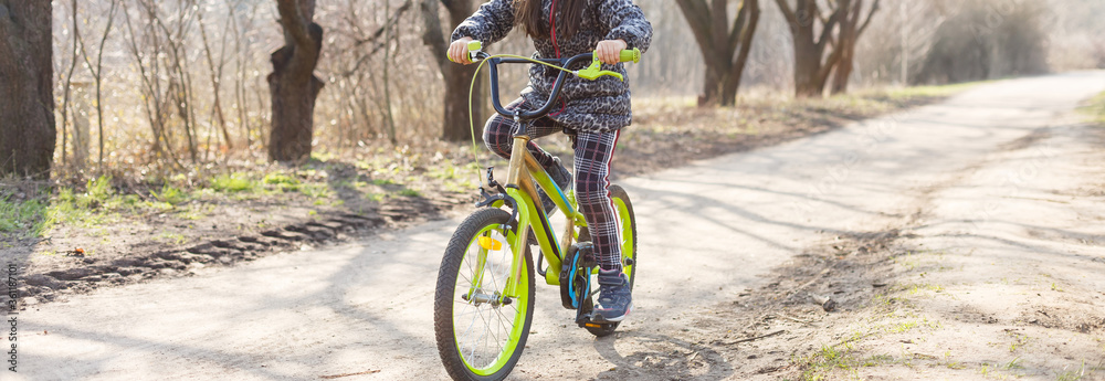Fototapeta premium Little girl wearing anti pollution mask on her bike at park.