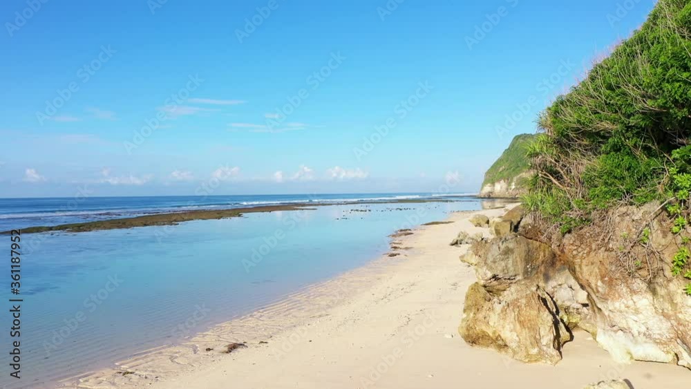 Beach scene - turquoise transparent ocean and white sand beach. Bali, Melasti beach, aerial 4k footage. Beach scene - turquoise transparent ocean and white sand beach. Bali, Melasti beach, aerial 4k footage.