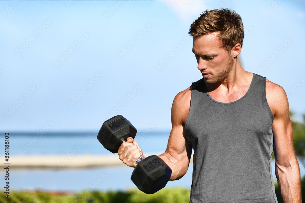Bicep curl free weights training fitness man outside working out arms  lifting dumbbells doing biceps curls. Fit man arm exercise workout  exercising arms with dumbbell weight at outdoor beach gym. Stock Photo