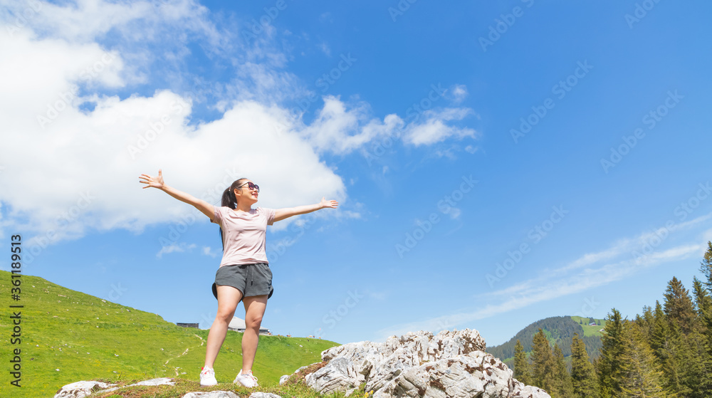 Beautiful Asian women with black hair and White skin wearing exercise clothes.she is standing Happy and smiling on the stone of the mountain, tourism of nature, Gantrischseeli at Switzerland, Beautiful Asian women with black hair and White skin wearing exercise clothes.she is standing Happy and smiling on the stone of the mountain, tourism of nature, Gantrischseeli at Switzerland,