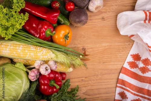 Fotografi Assortment of fresh raw vegetables on a wooden table