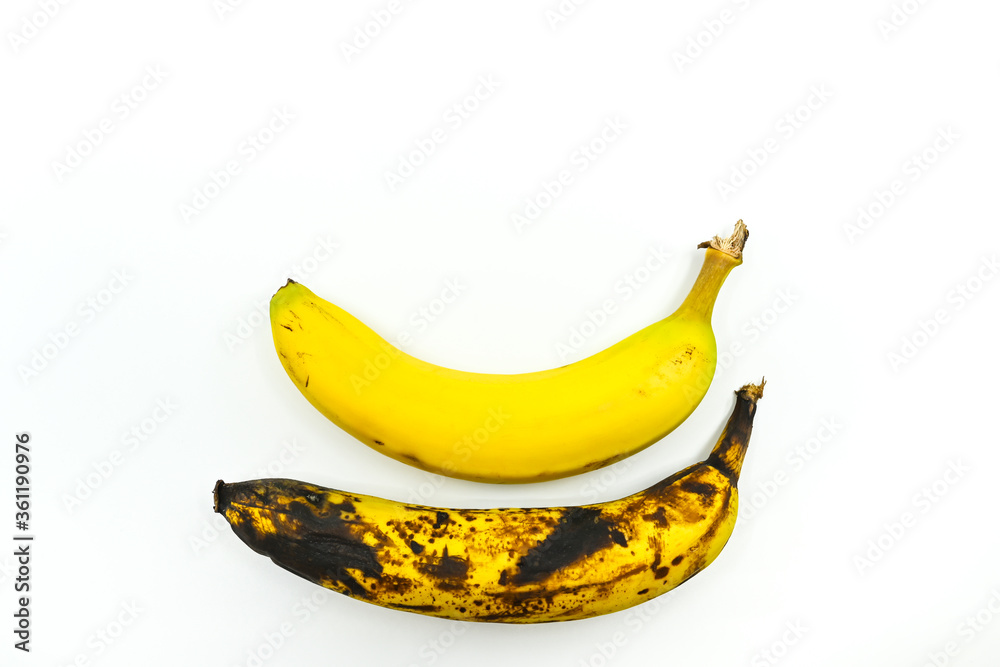 Two bananas side by side on a white background. One is ripe and one is rotting. No people. Space for copy above.