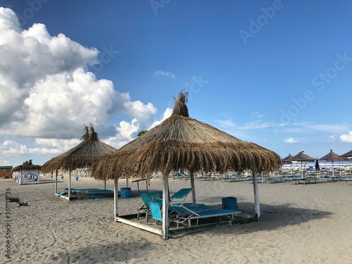 Beach Chairs and Umbrella on a beautiful bach in Durres, Albania.text © Xhemile