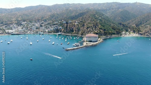 Aerial view of Catalina Bay and Avalon harbor with sailboats, fishing boats and yachts moored in calm bay, famous tourist attraction in Santa Catalina Island, Southern California photo
