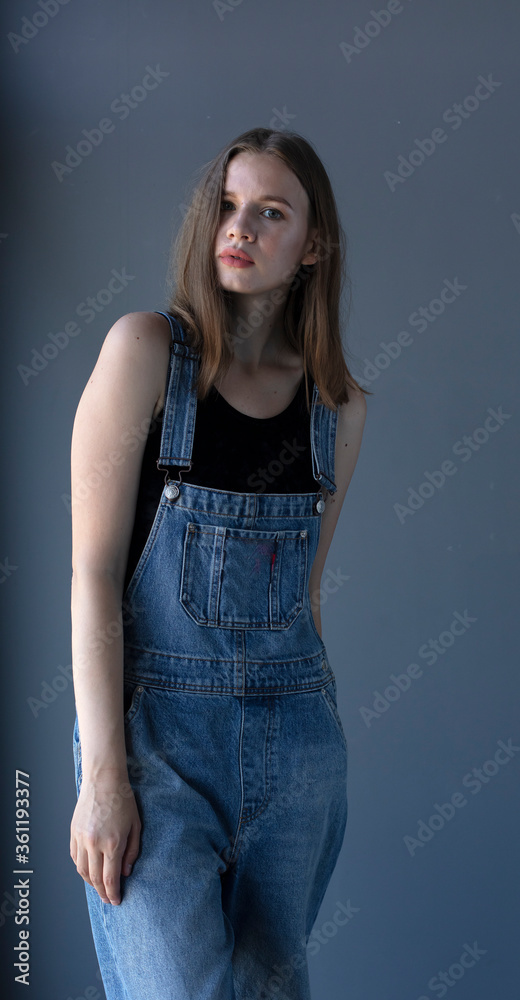 young girl in denim overalls, studio shooting young girl in denim overalls, studio shooting