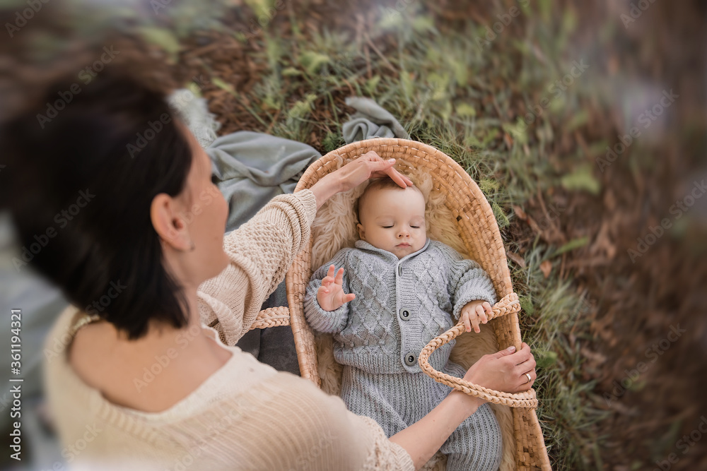 Caring for a baby. A large portrait of a small child lying in a wicker