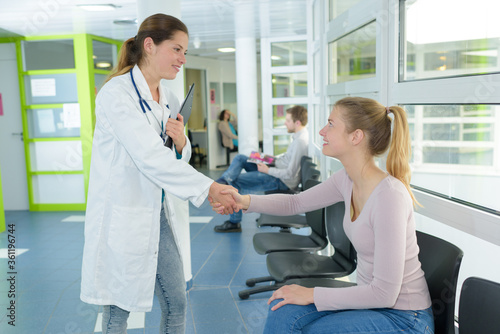 a doctor welcomes a patient