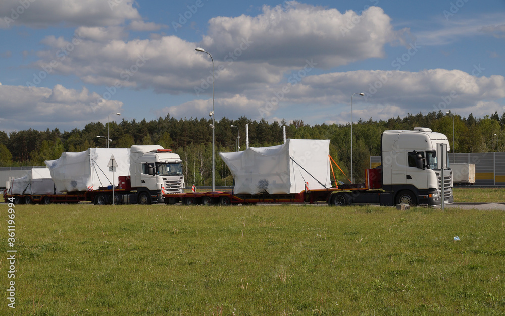 Oversize load or exceptional convoy. A trucks with a special semi-trailers for transporting oversized loads. Oversize load or exceptional convoy. A trucks with a special semi-trailers for transporting oversized loads.