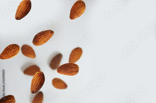 almonds fly on a white background. Composition of nuts flat lay almonds on white background. Concepts about decoration, healthy eating and food background.