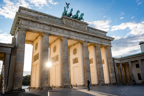 man standing in front of brandburg gate berlin germany during sunset