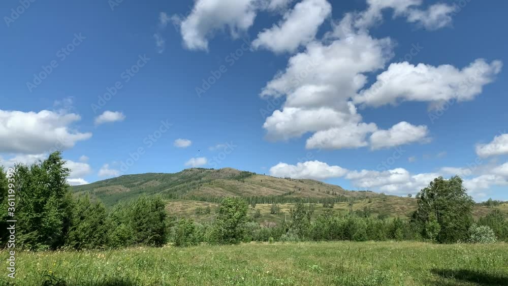 Panoramic view. Beautiful summer landscape. Mountains, blue sky and green fields, forest. Panoramic view. Beautiful summer landscape. Mountains, blue sky and green fields, forest.