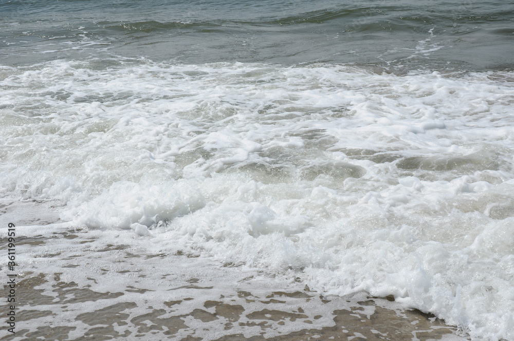 Foam sea wave running ashore Foam sea wave running ashore