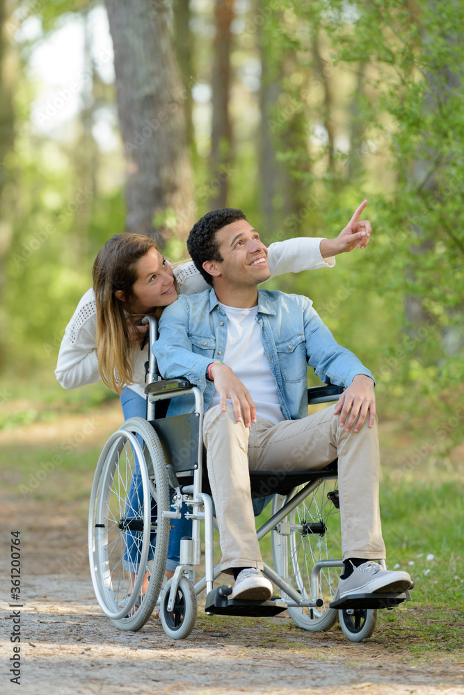 couple with wheelchair in autumn nature couple with wheelchair in autumn nature