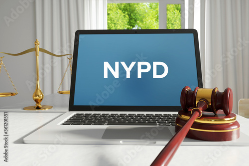 NYPD (New York City Police Department). Law. A lawyer laptop on a desk in the office. Text on the screen. Libra, Juctice, Web