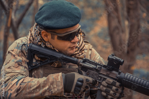 portrait of a soldier with a gun in the forest of Battlefield/army uniform with a weapon.
