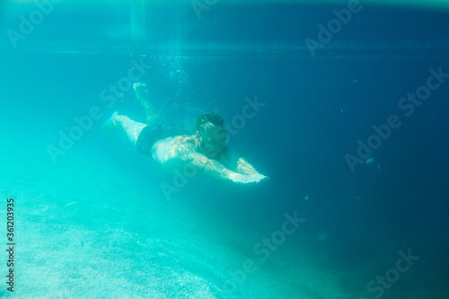 Man swimming underwater © destillat