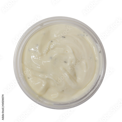 Garlic mayonnaise dip sauce in plastic tub isolated on white background. Top view