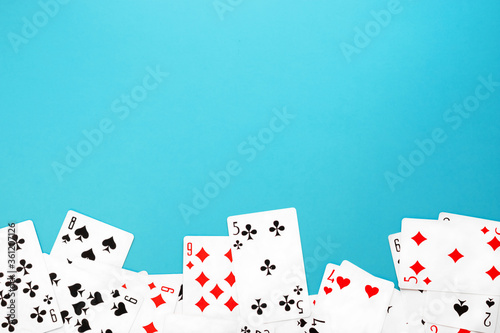 Deck of playing cards on blue background copy space