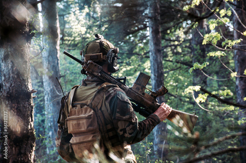 	
Soldier in a forest hiding in a foliage. Full equipment. soldier concept	
