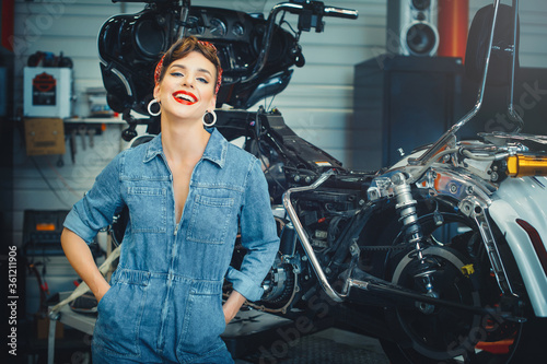 beautiful woman posing near a motorcycle