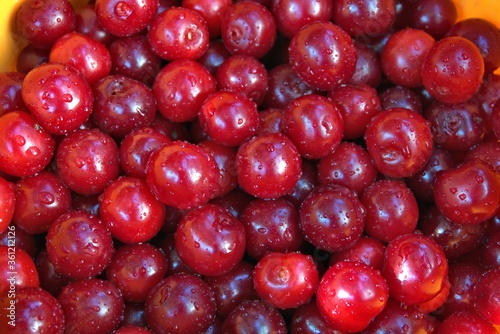 Many washed ripe red cherries in a bucket  nice food