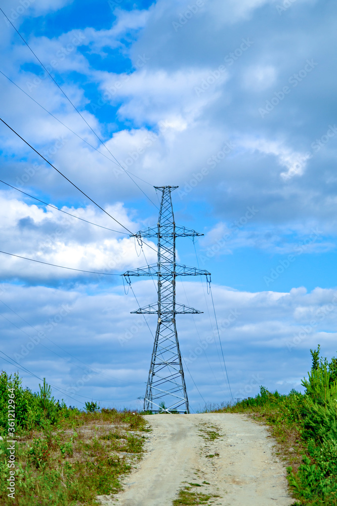 Obraz premium Power pole with wires against the blue sky. The correct form of metal construction