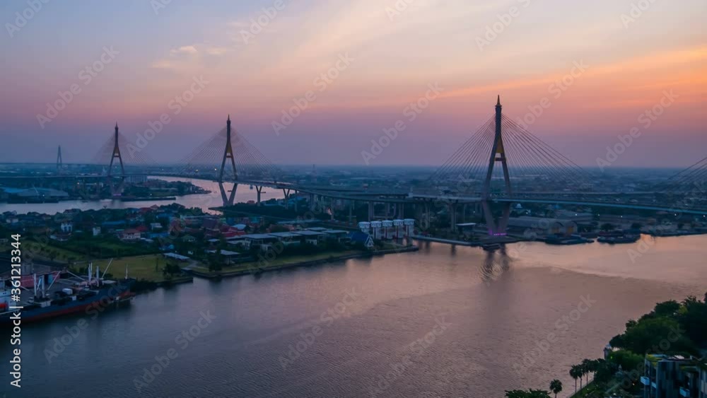 day to night time lapse of Bhumibol suspension bridge cross over Chao Phraya River at sunset in Bangkok city, Thailand day to night time lapse of Bhumibol suspension bridge cross over Chao Phraya River at sunset in Bangkok city, Thailand