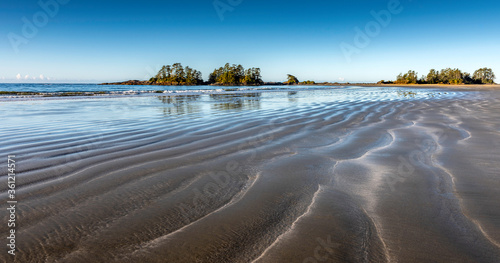 Beautiful ripples in the sand and a blue sky in Tofino Canada