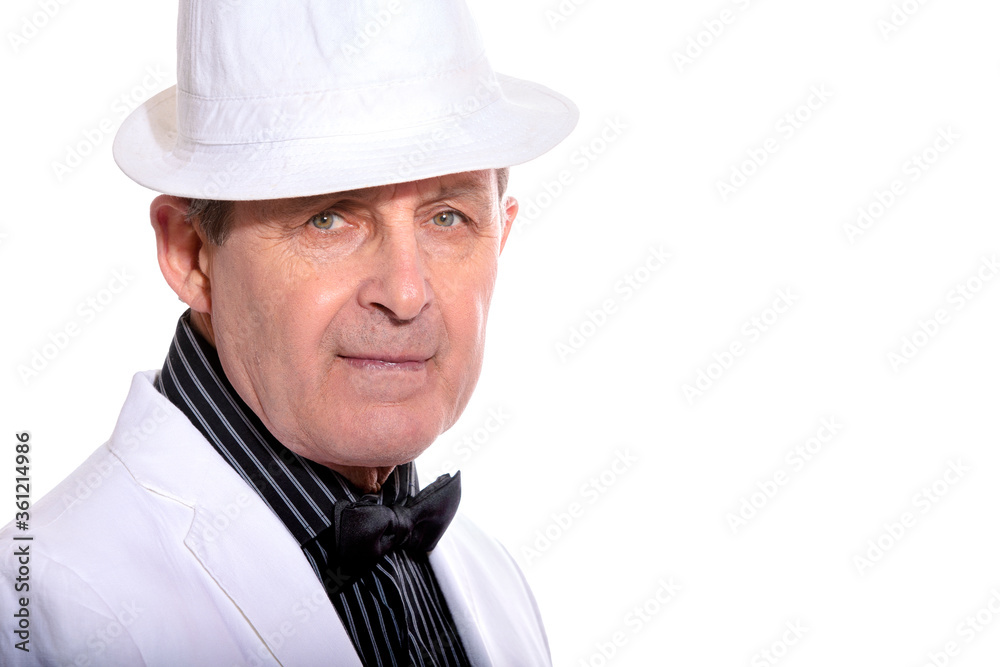 Attractive elderly man dressed in white with hat and elegant style Attractive elderly man dressed in white with hat and elegant style