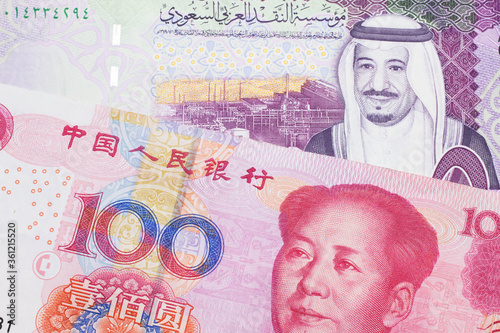 Wallpaper Mural A close up image of a five riyal note from Saudi Arabia along with a one hundred yuan bank note from the People's Republic of China Torontodigital.ca