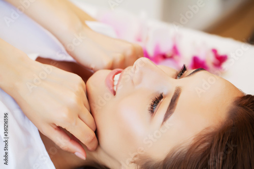 Spa treatment in beauty studio gets young beautiful woman relaxing