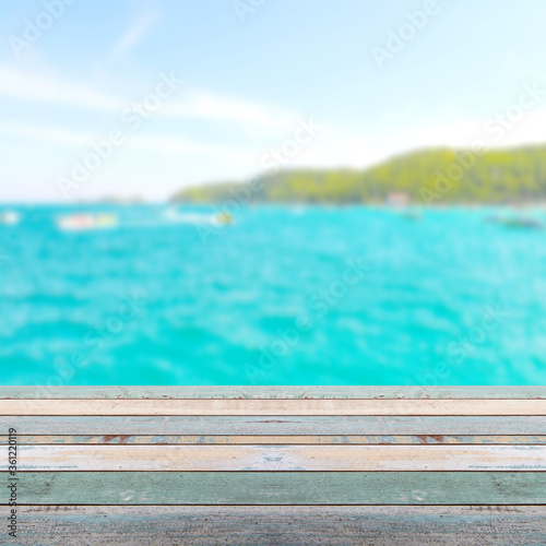 Wood table top with blurred nature scene tropical beach