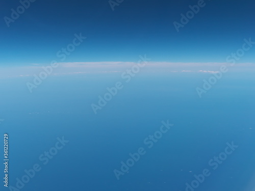 At sea, Japan-June 23, 2020: View of horizon from the window in the airplane 