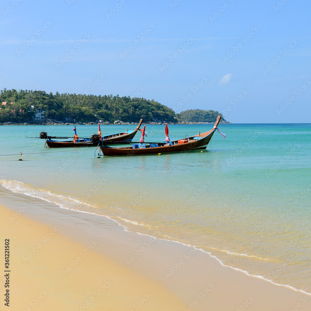 Long boat tail and tropical beach