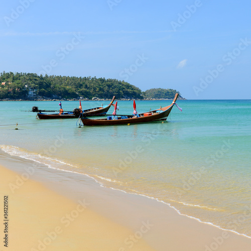 Long boat tail and tropical beach