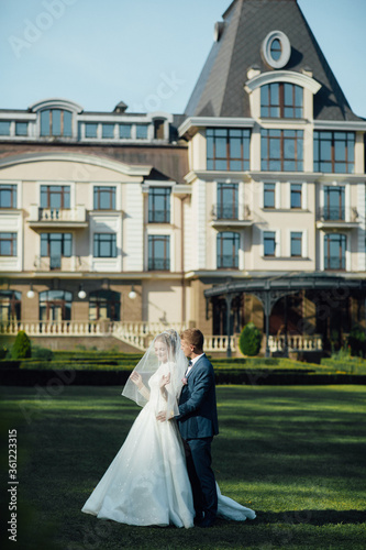 Portrait of the bride and groom with a bouquet of flowers in the park © ALEXSTUDIO